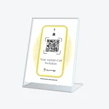 Buy Me a Coffee QR display sign inviting support at a workshop table